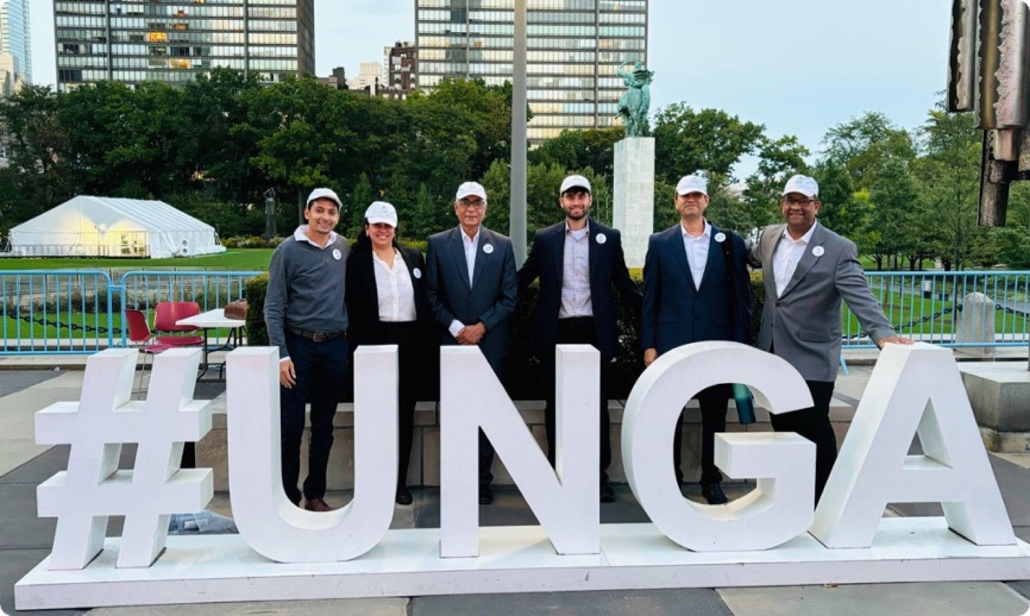 The Caregivers Asha Society delegation standing at the #UNGA installation on the United Nations Headquarters campus in New York.